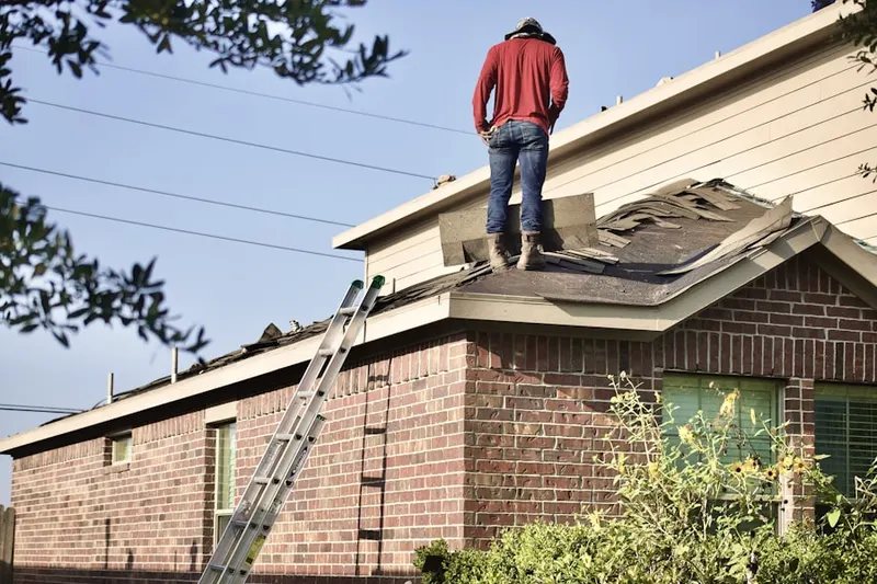 Professional roofer working on a residential roof in Providence Oaks